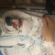Kaven is registered to the contest to win money with this photo: baby, bed, blanket, breathing_tube, care, clothing, hand, healthcare, hospital, incubator, infant, medical_equipment, monitoring_wires, nail_polish, newborn, person, premature_baby, swaddled, treatment, wristband