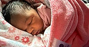 Kailani joined the competition — help win amazing prizes! baby, sleeping, newborn, child, portrait, face, closed_eyes, blanket, pink, floral, cozy, bed, indoors, sunlight, peaceful, resting, textile, snuggled, infant, photography
