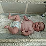 Royce is registered to the contest to win money with this photo: arms, baby, baby_toys, blanket, cartoon, child, cute, diaper, fabric, happy, head, indoors, infant, legs, lying_down, pattern, playpen, skin, smile, toddler