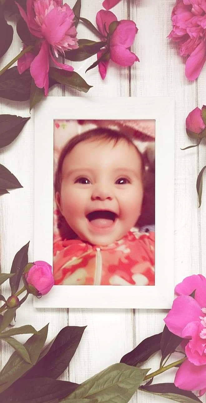 Brianna is registered to the contest to win money with this photo: baby, cheek, eye, eyelash, face, facial_expression, flower, happy, leaf, lip, material_property, person, petal, photograph, picture_frame, pink, purple, red, smile, textile