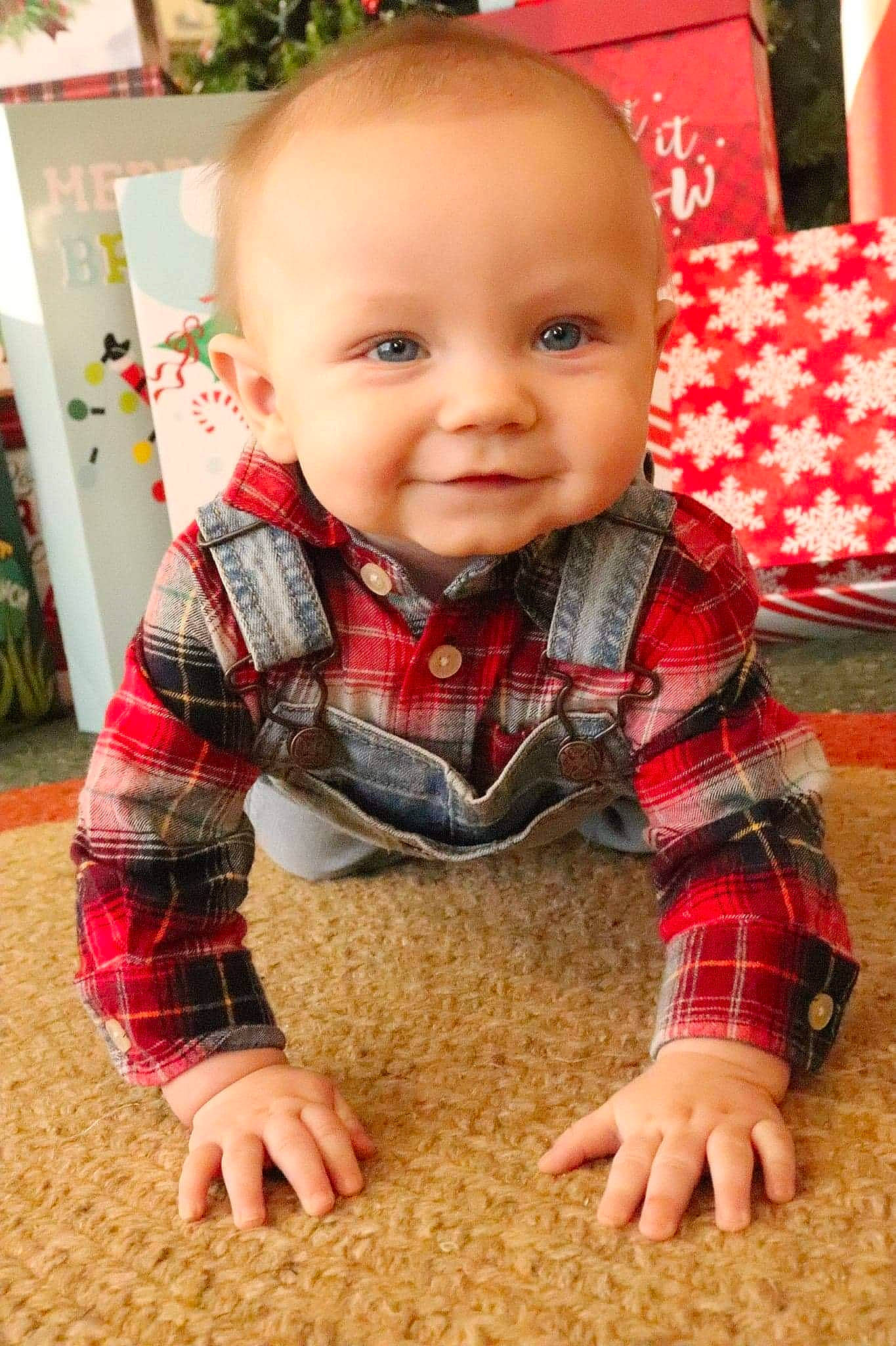 Fynnlee joined the competition — help win amazing prizes! baby, baby_toddler_clothing, child, eye, floor, flooring, fun, grass, happy, pattern, person, plaid, plant, sitting, skin, sleeve, smile, t_shirt, tartan, toddler