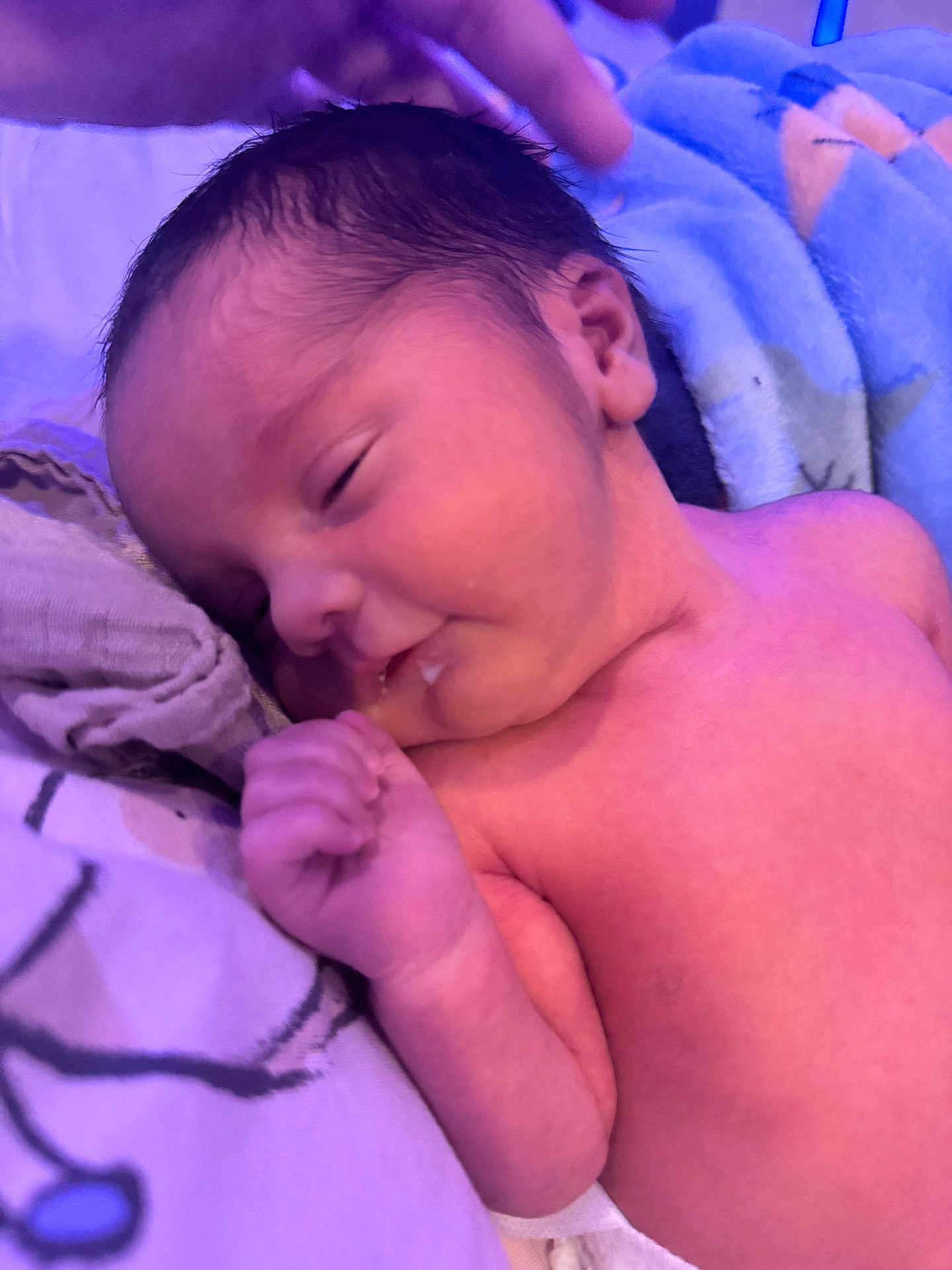 Zayan is registered to the contest to win money with this photo: baby, blanket, child, closeup, cute, early_morning, face, hand, indoors, infant, newborn, peaceful, person, portrait, purple_tone, resting, skin, sleeping, soft_light, toddler