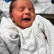 Zayan joined the competition — help win amazing prizes! baby, blanket, child, closeup, cozy, cute, face, hand, happy, indoor, infant, newborn, onesie, peaceful, person, portrait, sleeping, smiling, soft_texture, striped_clothing