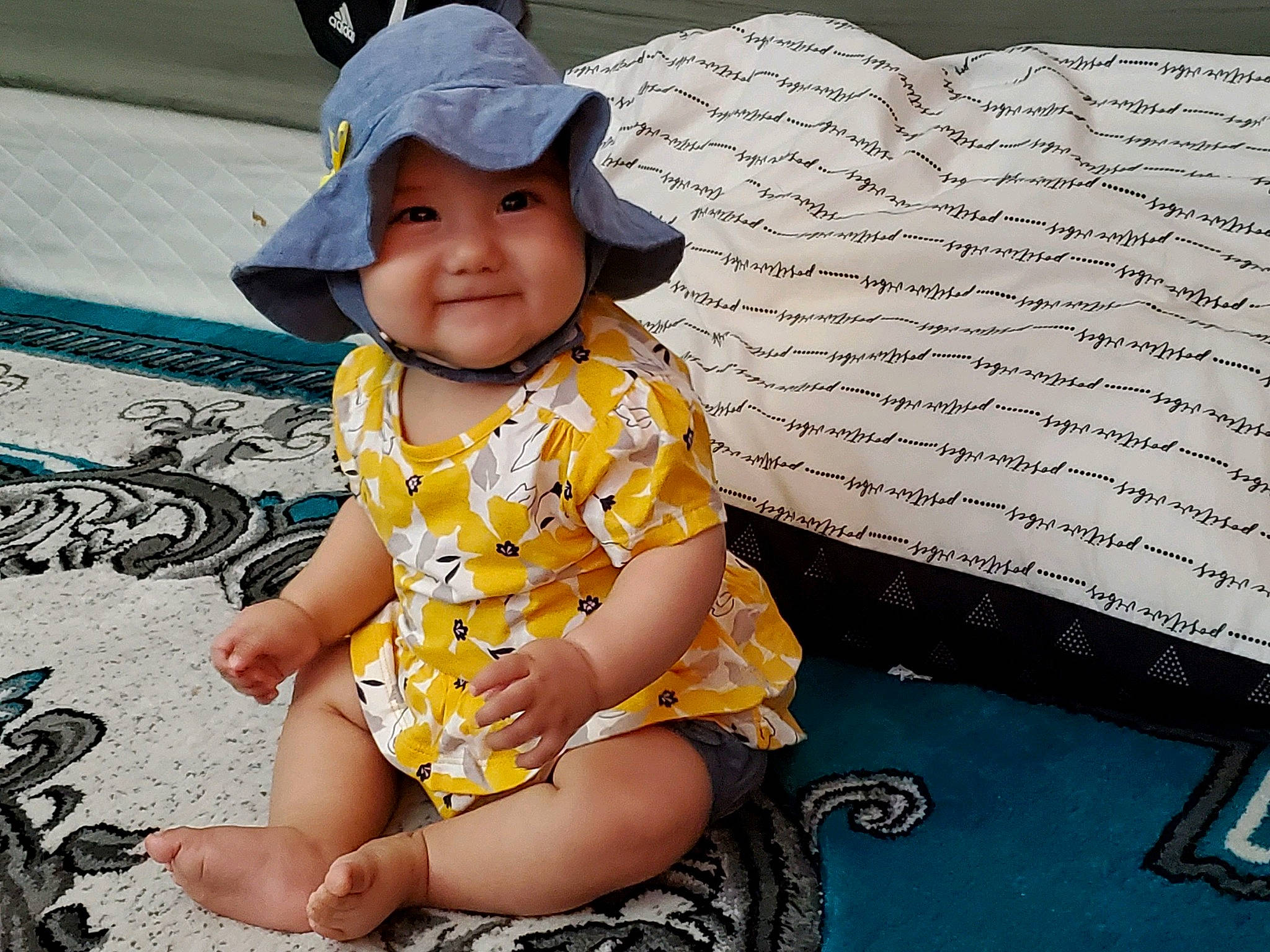 Abigail is registered to the contest to win money with this photo: baby_toddler_clothing, baseball_cap, cap, child, cool, fun, happy, hat, headwear, human, human_leg, joy, leg, leisure, pattern, person, sleeve, smile, sun_hat, t_shirt