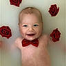 baby, bathtub, blue_eyes, bow_tie, closeup, cute, decorative_flowers, floating, flower, happy, infant, milk_bath, newborn, portrait, red_bow, red_roses, roses, skin, smile, water