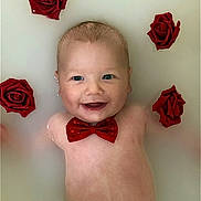 Diesel is registered to the contest to win money with this photo: baby, bathtub, blue_eyes, bow_tie, closeup, cute, decorative_flowers, floating, flower, happy, infant, milk_bath, newborn, portrait, red_bow, red_roses, roses, skin, smile, water