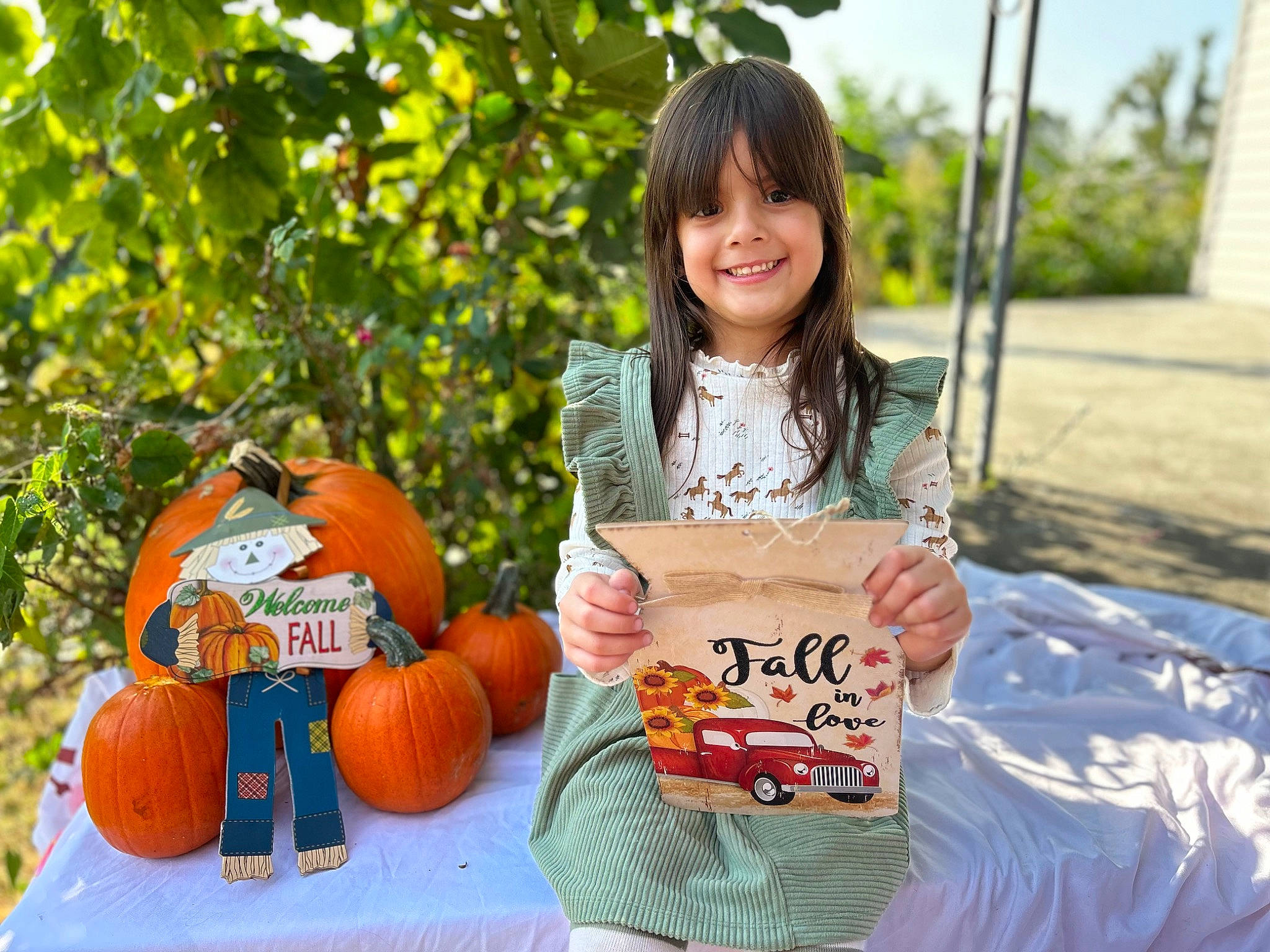 Carina joined the competition — help win amazing prizes! calabaza, cucurbita, facial_expression, gourd, grass, happy, joy, leaf, leisure, natural_foods, orange, person, plant, pumpkin, shorts, smile, squash, t_shirt, tree, vegetable
