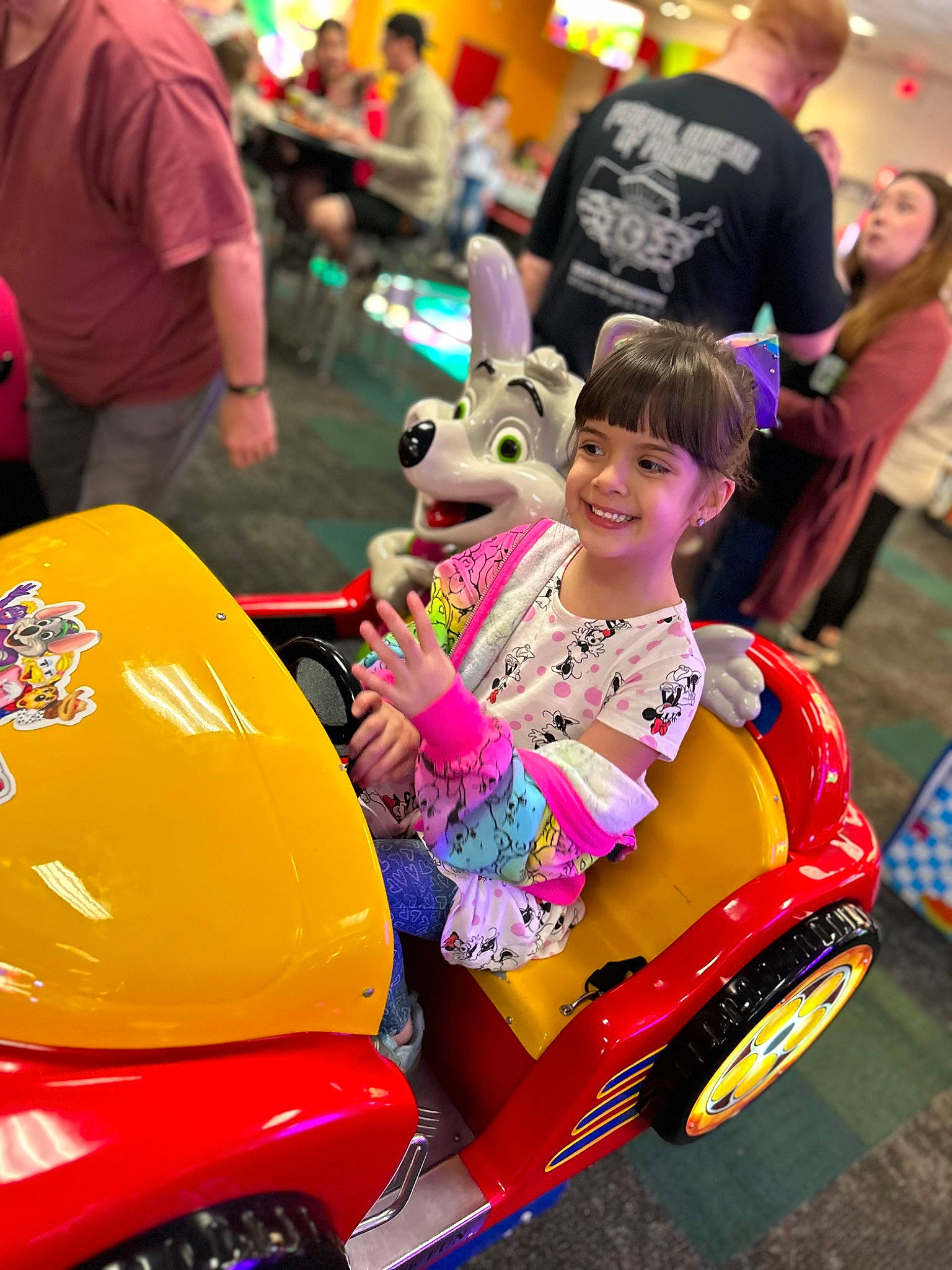 Carina is registered to the contest to win money with this photo: automotive_exterior, automotive_tire, event, fun, happy, joy, leisure, magenta, motor_vehicle, outerwear, person, pink, product, recreation, red, riding_toy, smile, t_shirt, tire, toddler