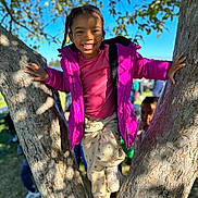 Arianna is registered to the contest to win money with this photo: child, clothing, coat, face, female, footwear, girl, head, jacket, outdoors, pants, person, photography, plant, portrait, purple, shoe, tree, treetrunk, wood