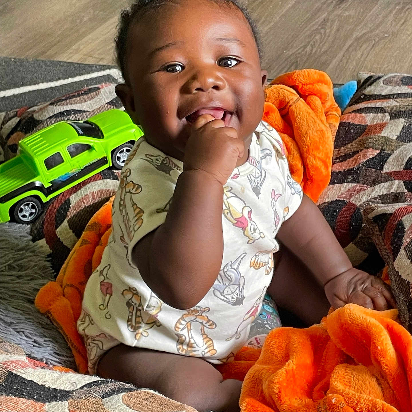 Giovanni Amire is registered to the contest to win money with this photo: baby, babylaughing, biting, blanket, car, clothing, couch, face, furniture, happy, head, machine, person, photography, portrait, sitting, smile, transportation, vehicle, wheel