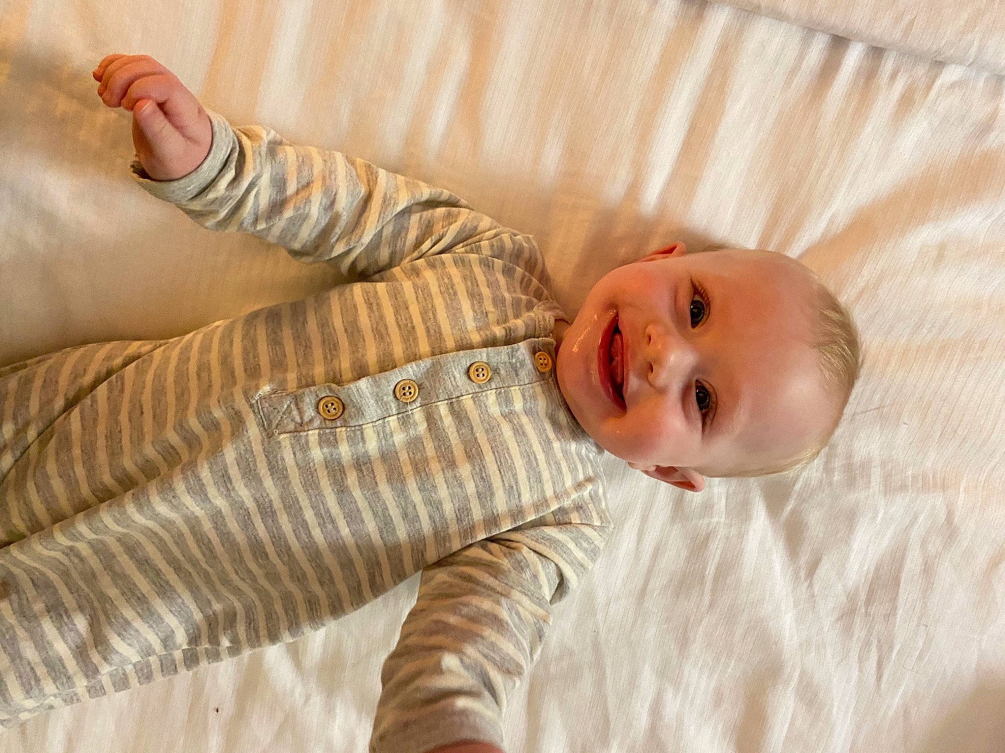 Hunter joined the competition — help win amazing prizes! baby, baby_toddler_clothing, child, comfort, elbow, floor, flooring, happy, hardwood, human_leg, joy, linens, pattern, person, room, sitting, skin, sleeve, smile, textile