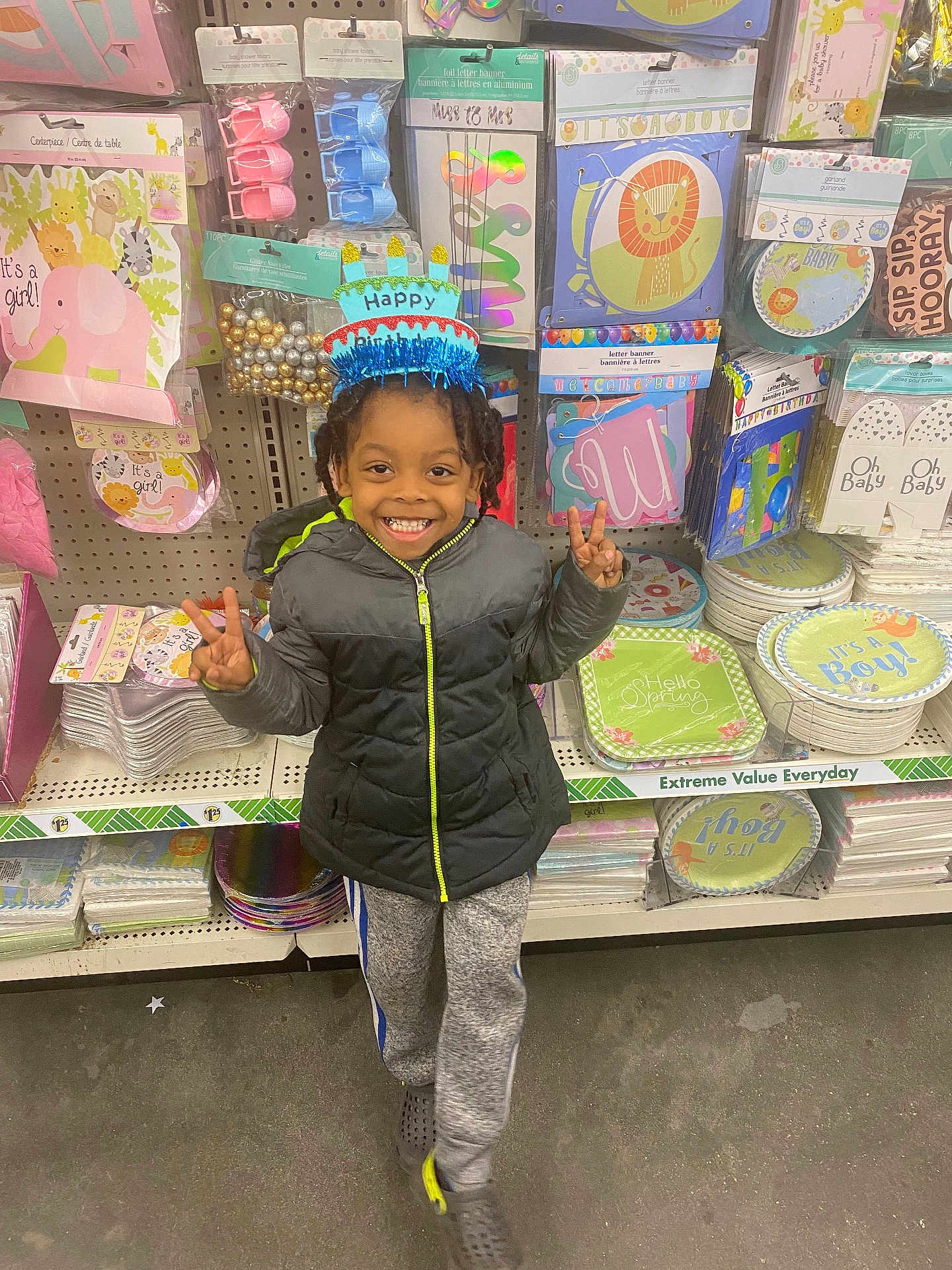 Isaiah joined the competition — help win amazing prizes! child, birthday_hat, smiling, peace_sign, party_supplies, store_aisle, jackets, sweatpants, crocs, happy, indoor, colorful, celebration, toys, decorations, face, person, retail, shopping, floor