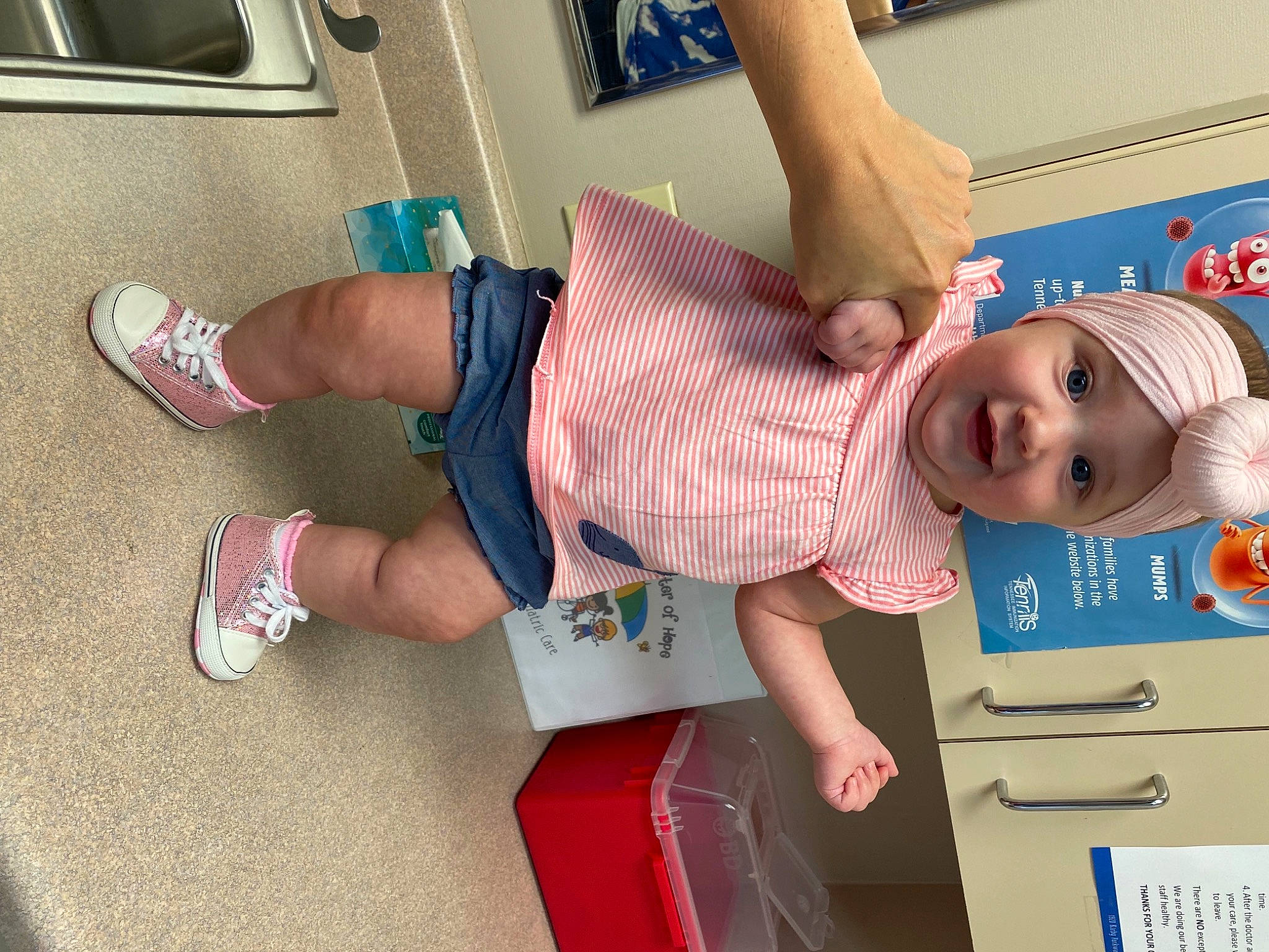 Jessi is registered to the contest to win money with this photo: baby, baby_toddler_clothing, child, dress, finger, foot, fun, hat, headwear, human_body, human_leg, knee, leg, person, play, shorts, smile, sneakers, sock, t_shirt