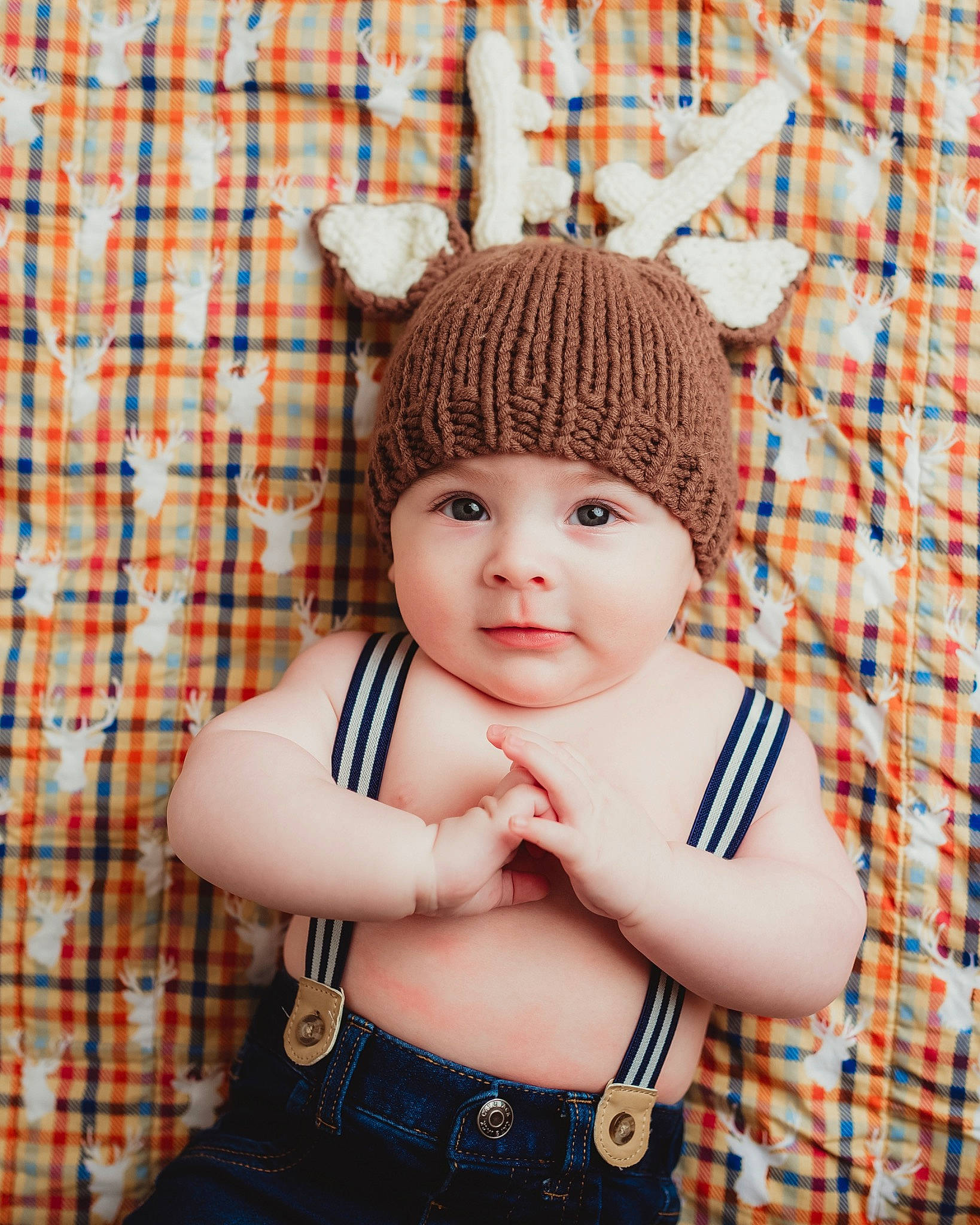 Henrik is registered to the contest to win money with this photo: baby, baby_toddler_clothing, beanie, cap, child, craft, fashion_accessory, headgear, headwear, knit_cap, magenta, pattern, person, plaid, sitting, sleeve, tartan, textile, toddler, wool