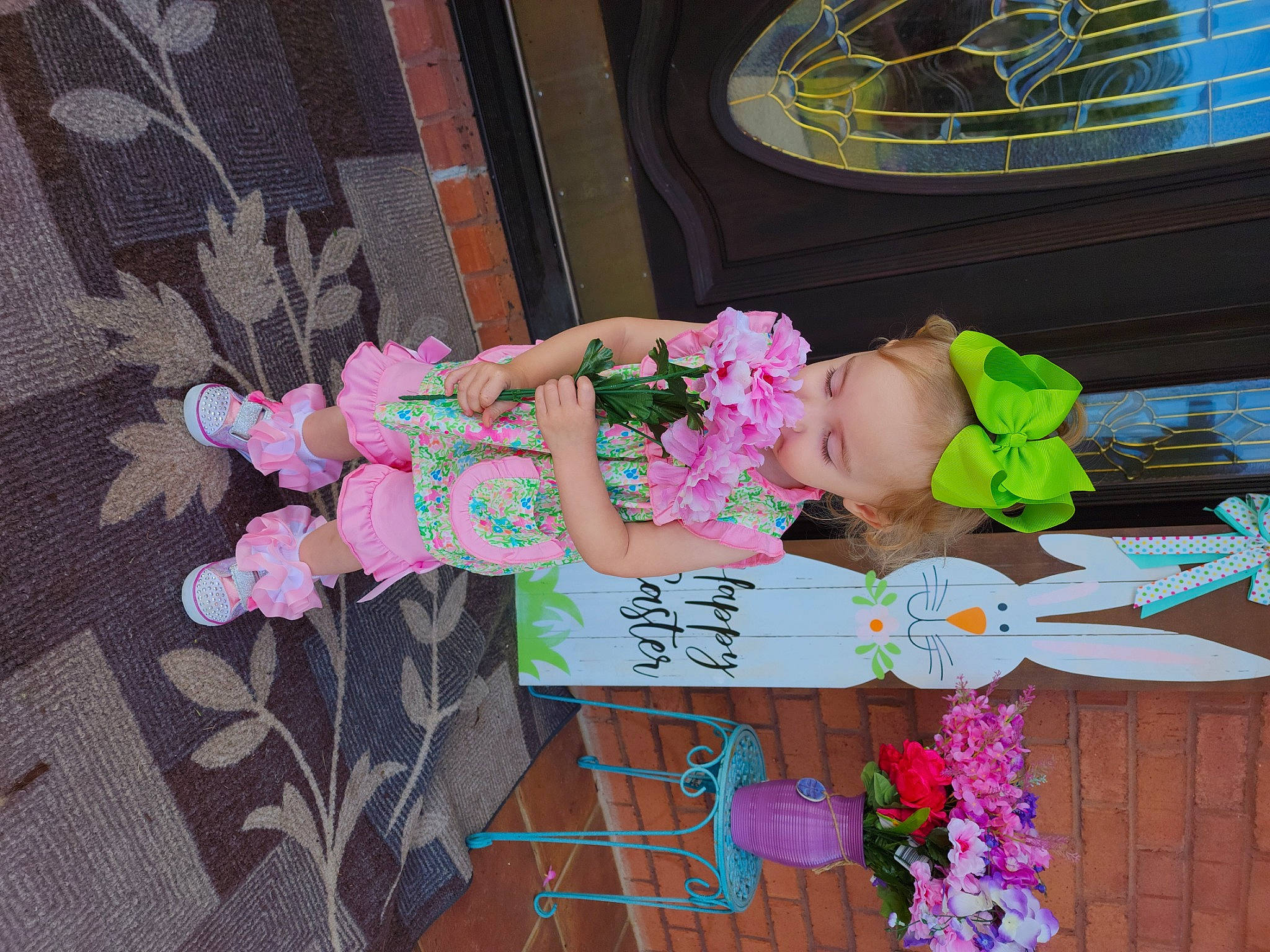 Vivi is registered to the contest to win money with this photo: artificial_flower, child, cut_flowers, dress, event, floral_design, floristry, flower, flower_arranging, house, magenta, pattern, peach, person, petal, pink, plant, room, toddler, toy