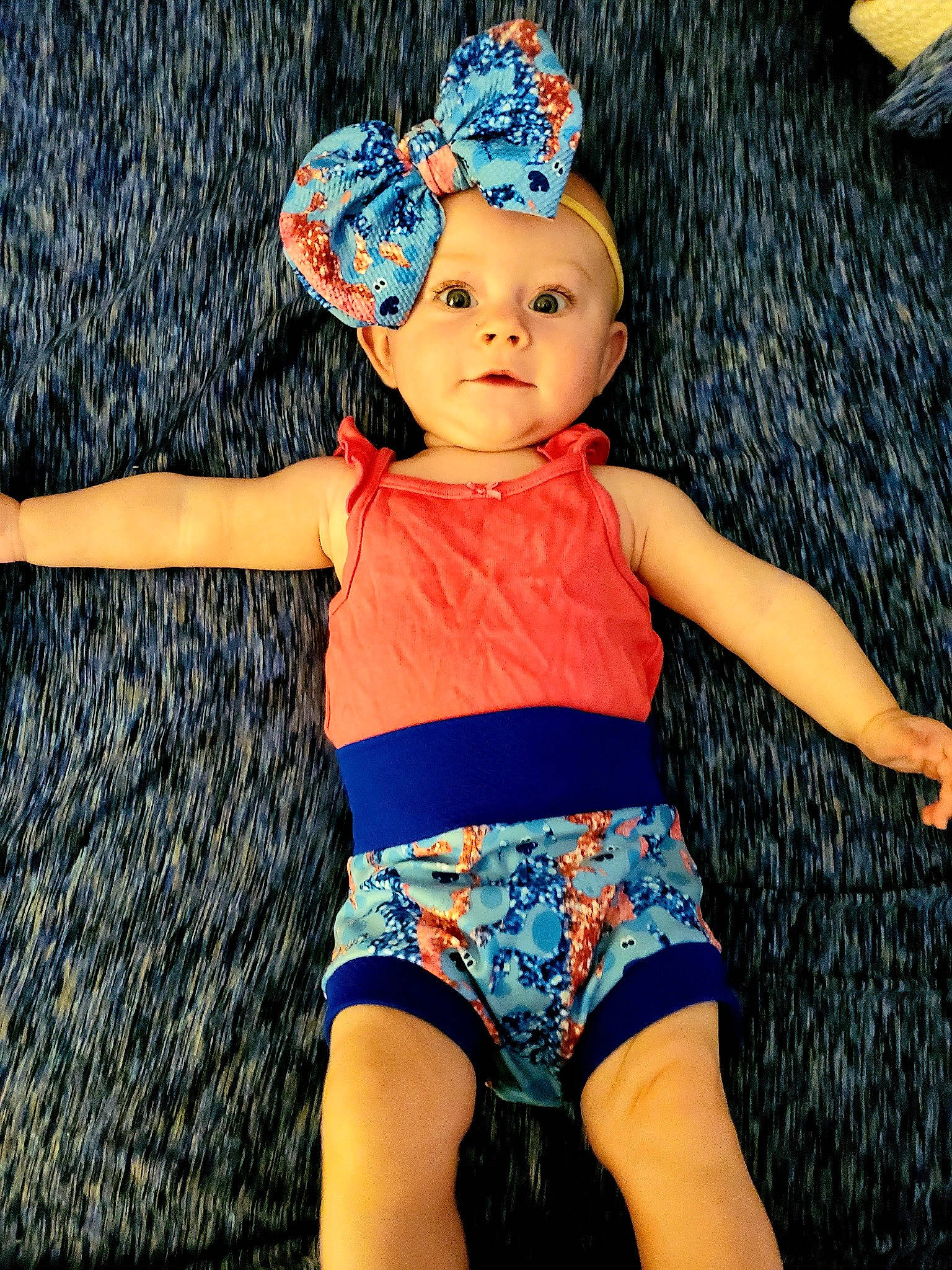 Lilith is registered to the contest to win money with this photo: abdomen, baby, baby_bloomers, baby_products, baby_toddler_clothing, cap, child, clothing, costume_accessory, design, electric_blue, fashion_accessory, hair_accessory, headgear, headwear, pattern, person, product, toddler, trunk