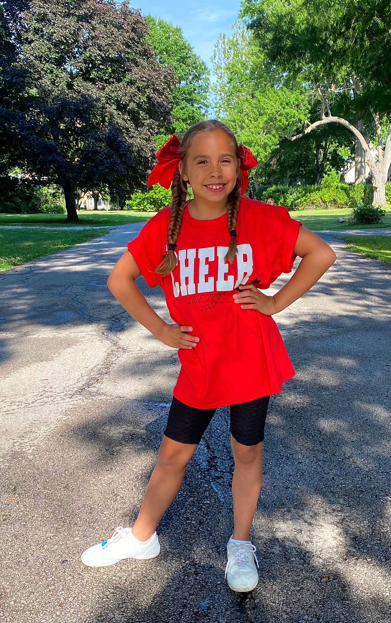 Temperance is registered to the contest to win money with this photo: asphalt, electric_blue, fun, happy, hat, human_leg, joy, leisure, magenta, person, pink, plant, recreation, sleeve, smile, sportswear, t_shirt, thigh, toddler, tree