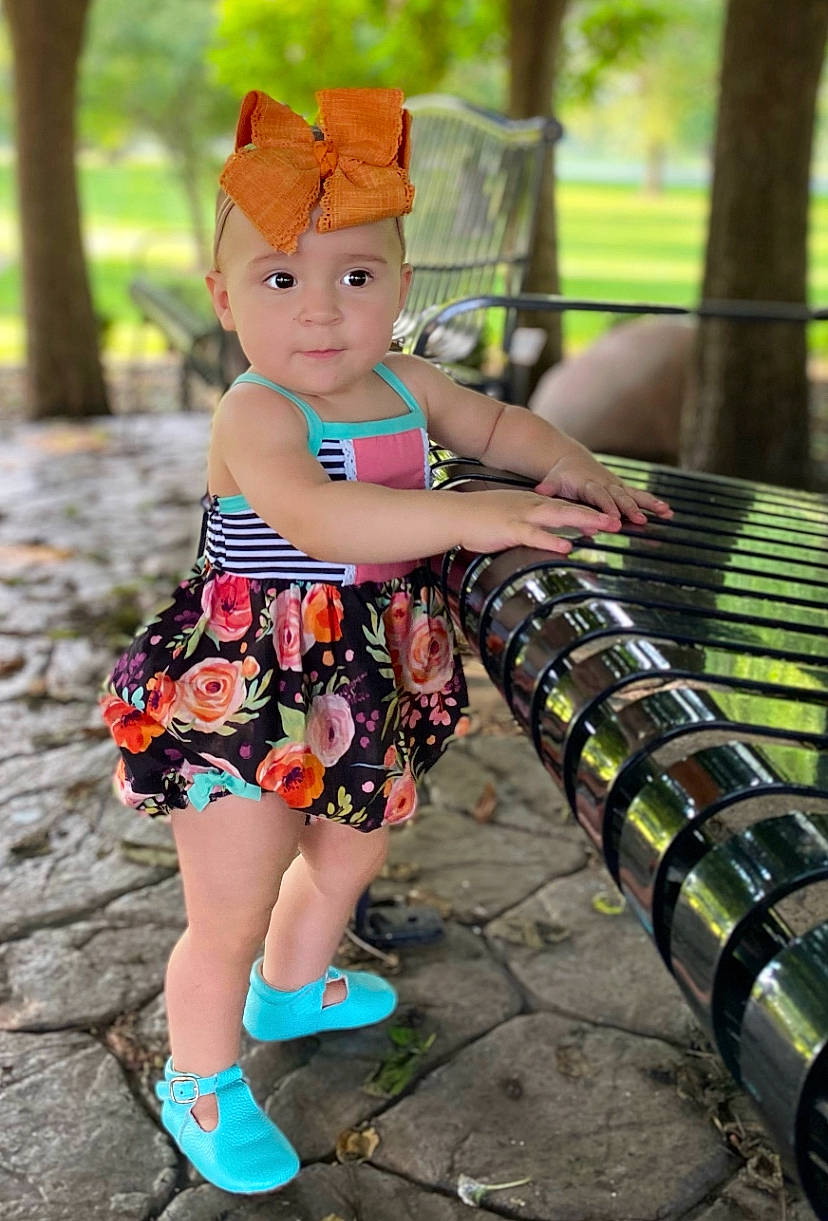 Adley is registered to the contest to win money with this photo: cool, fawn, footwear, fun, grass, green, hairstyle, happy, headwear, leisure, pattern, people_in_nature, person, plant, recreation, sneakers, street_fashion, style, textile, thigh