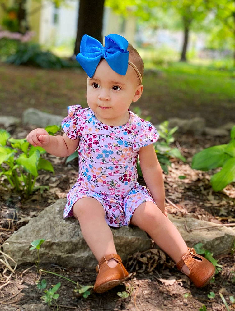 Adley is registered to the contest to win money with this photo: baby, baby_toddler_clothing, cap, child, electric_blue, fashion_accessory, fun, grass, happy, hat, headwear, leisure, magenta, pattern, people_in_nature, person, plant, sitting, sleeve, soil