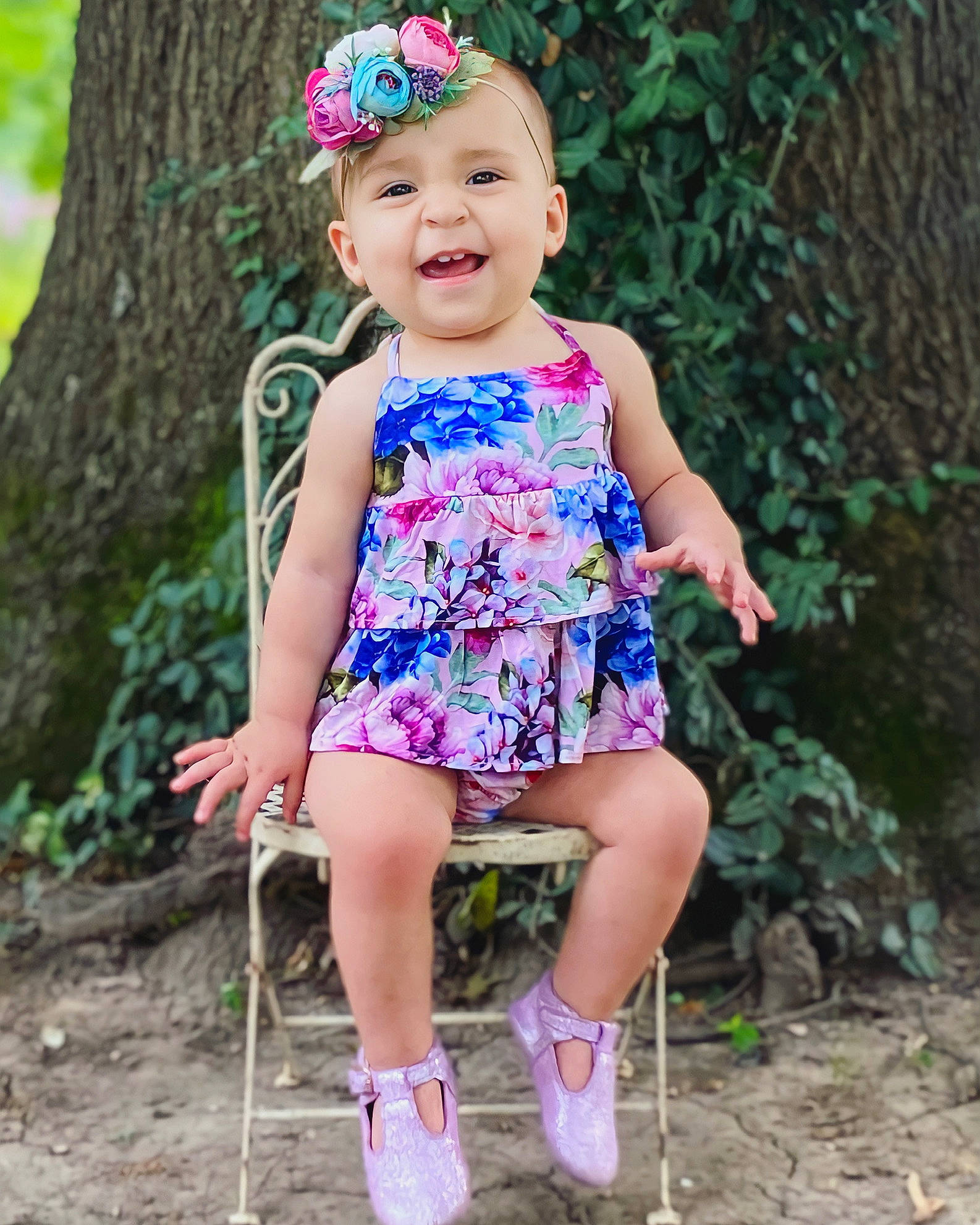 Adley is registered to the contest to win money with this photo: baby_toddler_clothing, day_dress, dress, eye, face, grass, happy, head, headwear, leaf, leg, people_in_nature, person, photograph, pink, plant, purple, shoe, skin, smile