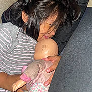 Jaretssi is registered to the contest to win money with this photo: bottle, child, closeup, comfort, cushion, doll, face, girl, hair, hand, home, indoors, peaceful, portrait, relaxation, resting, sleeping, soft_lighting, striped_clothing, toy