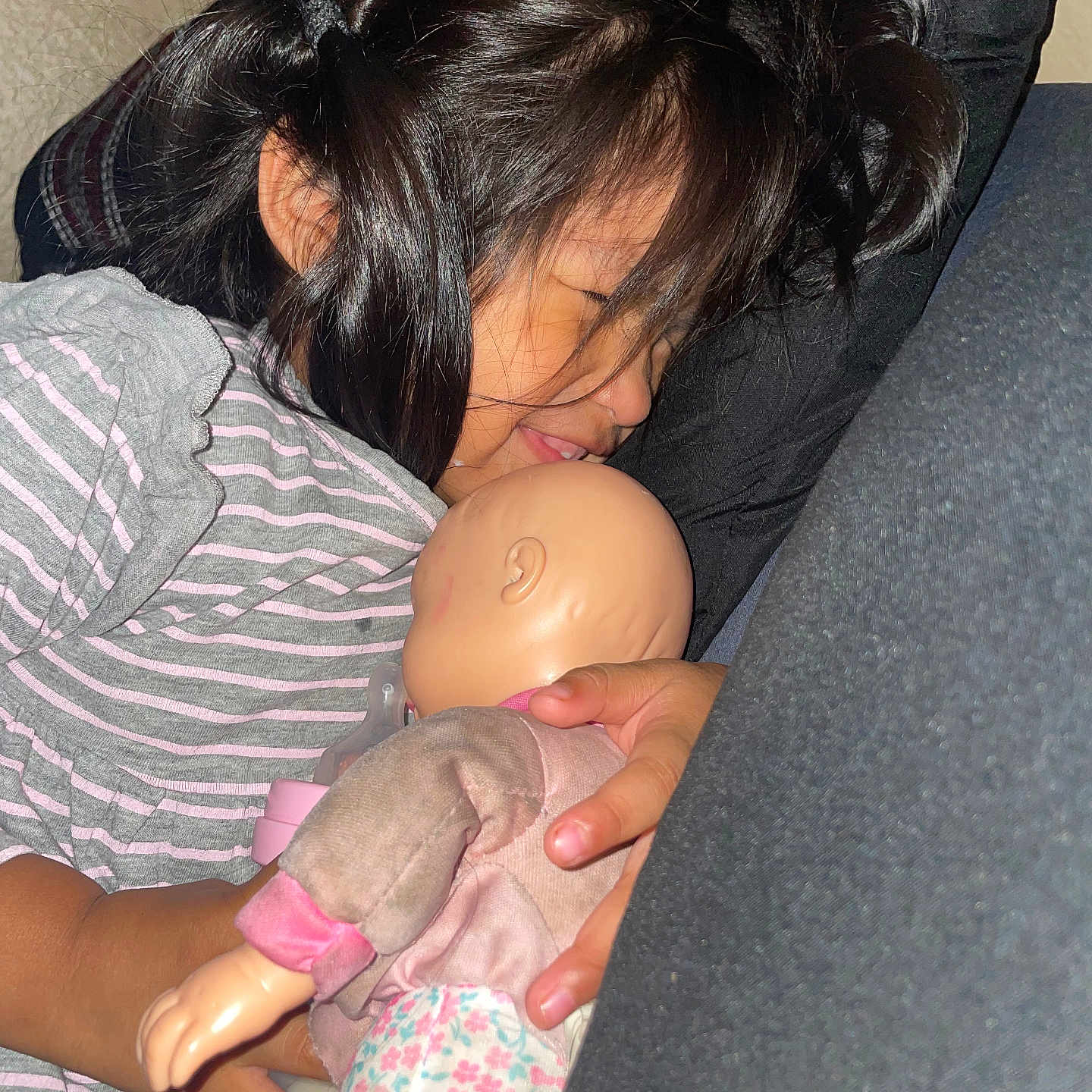 Jaretssi is registered to the contest to win money with this photo: bottle, child, closeup, comfort, cushion, doll, face, girl, hair, hand, home, indoors, peaceful, portrait, relaxation, resting, sleeping, soft_lighting, striped_clothing, toy