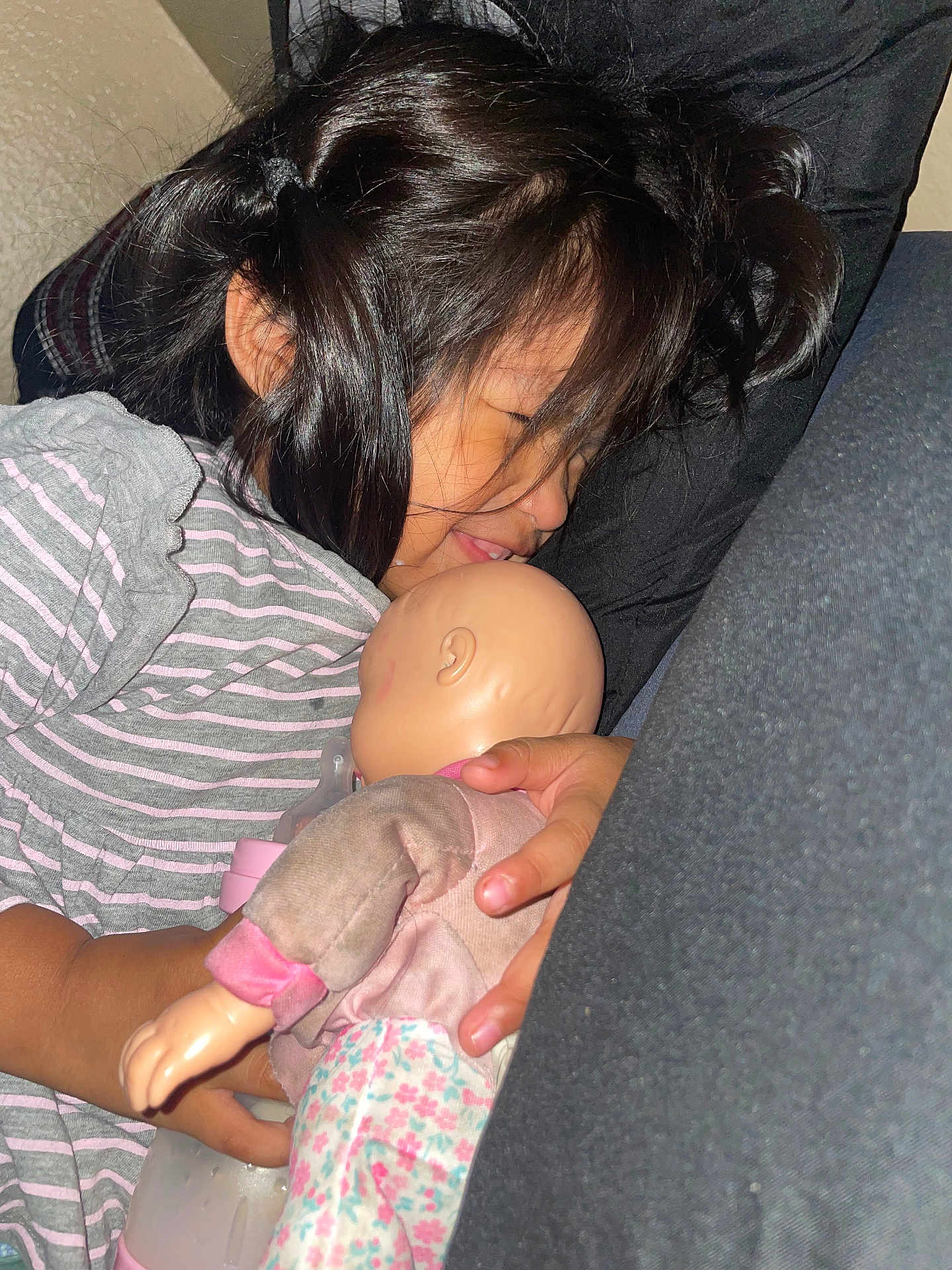 Jaretssi is registered to the contest to win money with this photo: bottle, child, closeup, comfort, cushion, doll, face, girl, hair, hand, home, indoors, peaceful, portrait, relaxation, resting, sleeping, soft_lighting, striped_clothing, toy