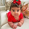 baby, child, infant, portrait, smiling, wide_eyes, red_outfit, hair_bow, cherry_bow, sitting, crawling, sofa, couch, cushions, indoor, home, close_up, adorable, bracelet, photography
