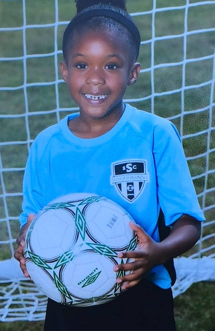 London joined the competition — help win amazing prizes! ball, ball_game, competition_event, electric_blue, face, football, grass, happy, head, joy, person, player, playing_sports, shorts, smile, soccer, soccer_ball, sports, sports_equipment, sports_uniform