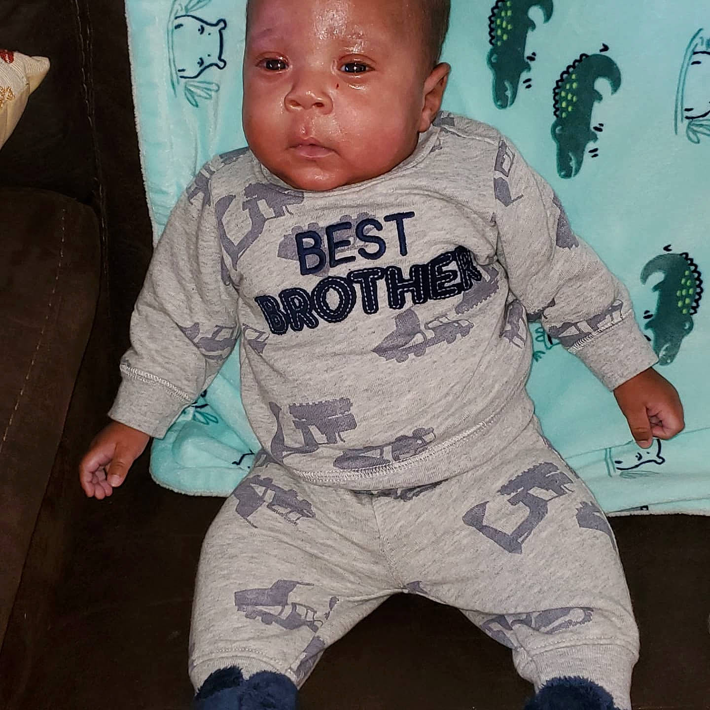 Everett is registered to the contest to win money with this photo: baby, baby_toddler_clothing, cheek, child, cool, electric_blue, eye, finger, flooring, happy, head, long_sleeved_t_shirt, pajamas, pattern, person, personal_protective_equipment, sleeve, sportswear, t_shirt, thumb