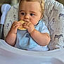 baby, child, cookie, high_chair, blue_bib, animal_print, toddler, eating, food, cute, indoor, portrait, infant, clothing, hands, face, hair, seat, snack, focus