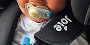 Louie joined the competition — help win amazing prizes! baby, child, pacifier, car_seat, seatbelt, smiling, closeup, face, blond_hair, white_shirt, infant, cute, strapped_in, safety, car_interior, hand, blue_clip, joyful, comfort, young