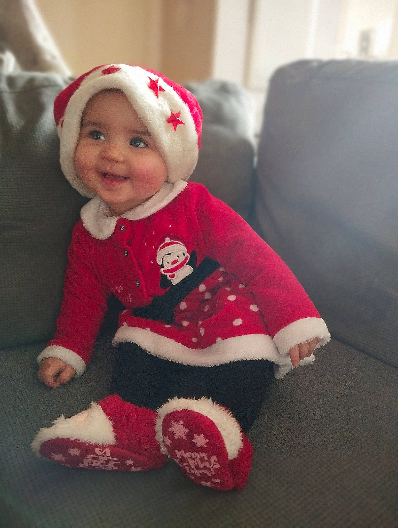 Rose participe au concours pour gagner de l'argent avec cette photo : baby, baby_toddler_clothing, beanie, carmine, child, christmas, comfort, flooring, fur, happy, hat, headwear, holiday, joy, mammal, pattern, person, room, sitting, sleeve