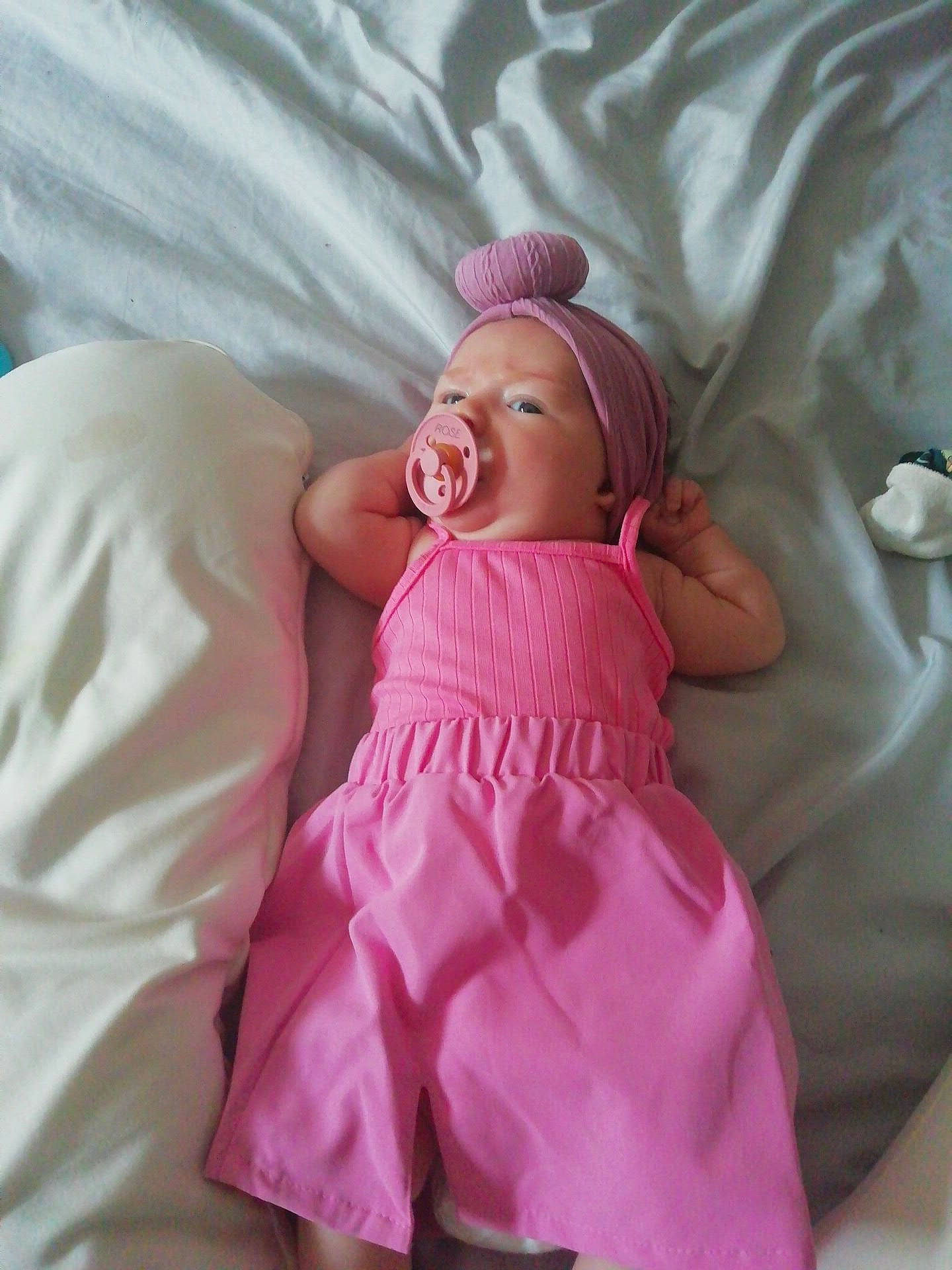 Rose participe au concours pour gagner de l'argent avec cette photo : arm, baby, baby_products, baby_sleeping, baby_toddler_clothing, bedding, cap, child, comfort, doll, hat, leg, linens, magenta, peach, person, pink, sleeve, textile, thumb