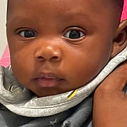 Jasia joined the competition — help win amazing prizes! baby, infant, face, eyes, hand, holding, clothing, blanket, star_pattern, person, portrait, indoor, cute, young_child, skin, head, expression, close_up, newborn, baby_girl