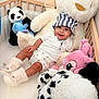 Kayden a rejoint le concours — aidez-le/la à gagner de superbes lots ! baby, child, crib, stuffed_animal, plush_toy, panda, pink_toy, blue_toy, hat, smile, happy, boots, white_clothing, indoor, soft_toy, cute, childrens_room, cozy, playroom, infant