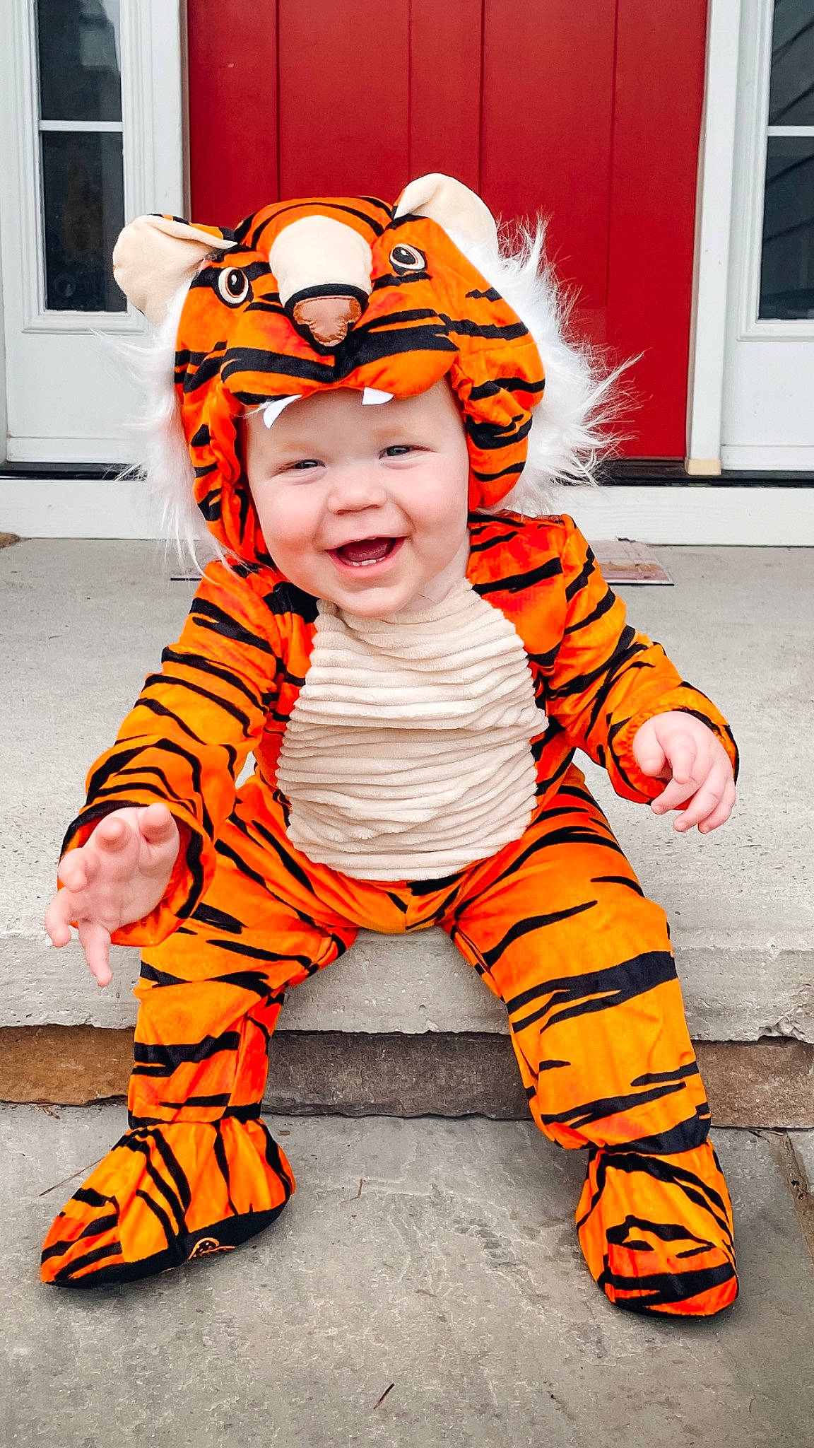 Bryant is registered to the contest to win money with this photo: baby_toddler_clothing, child, cool, door, fun, fur, happy, hat, head, headwear, joy, orange, outerwear, pattern, peach, person, personal_protective_equipment, sleeve, smile, toddler