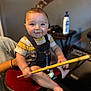 Wesley is registered to the contest to win money with this photo: amplifier, baby, barefoot, bottle, child, drumstick, guitar, hand, happy, indoor, infant, music, overalls, person, room, smile, stool, striped_shirt, support, table