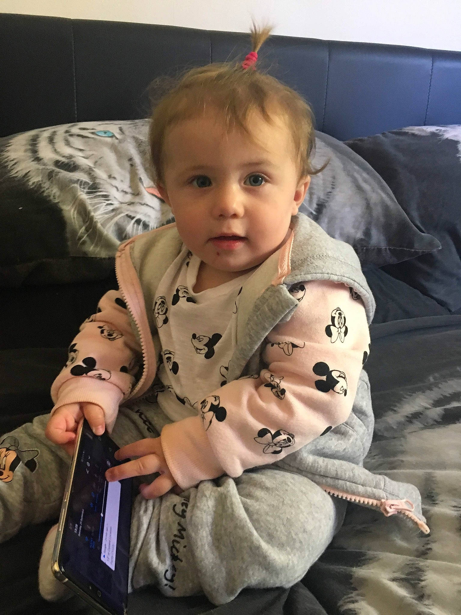 Amelia is registered to the contest to win money with this photo: arm, baby, cheek, child, electronic_device, person, sitting, sleeve, toddler