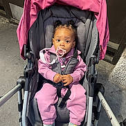 Kahmiya joined the competition — help win amazing prizes! baby, stroller, pacifier, pink_clothing, sneakers, child, urban, sidewalk, cute, infant, hair_buns, jacket, pants, sitting, outdoor, person, footwear, seat_belt, expression, young_child