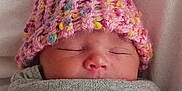 Matilda joined the competition — help win amazing prizes! baby, newborn, sleeping, hat, knitted_hat, pink, colorful, blanket, wrapped, cozy, soft, face, closed_eyes, infant, cute, resting, indoors, warm, child, portrait