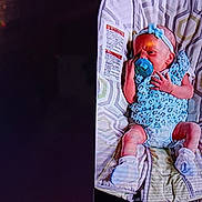 Lizzy is registered to the contest to win money with this photo: baby, infant, pacifier, headband, blue_outfit, booties, cushion, patterned, newborn, lying_down, indoor, cute, child, small_hands, small_feet, sleepy, resting, soft_lighting, adorable, cozy