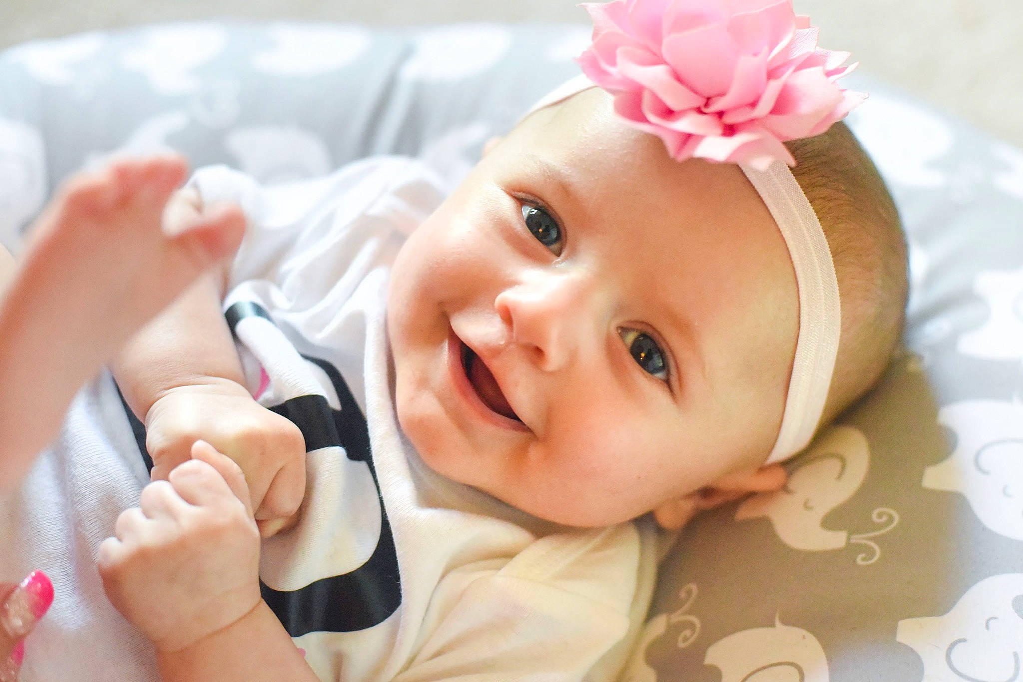 Ryan is registered to the contest to win money with this photo: baby, beauty, cheek, child, child_model, ear, fashion_accessory, finger, hair_accessory, hand, happy, head, headband, headgear, headpiece, joy, person, photography, pink, skin