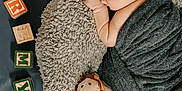 Remy joined the competition — help win amazing prizes! newborn, baby, sleeping, blanket, plush_toy, lion, alphabet_blocks, letters, soft_texture, cushion, wrapped, infant, child, resting, cozy, indoor, cute, portrait, peaceful, nursery