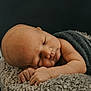 newborn, baby, sleeping, blanket, cushion, soft_texture, infant, peaceful, resting, portrait, closeup, skin, hands, head, face, cozy, warm, indoor, calm, child