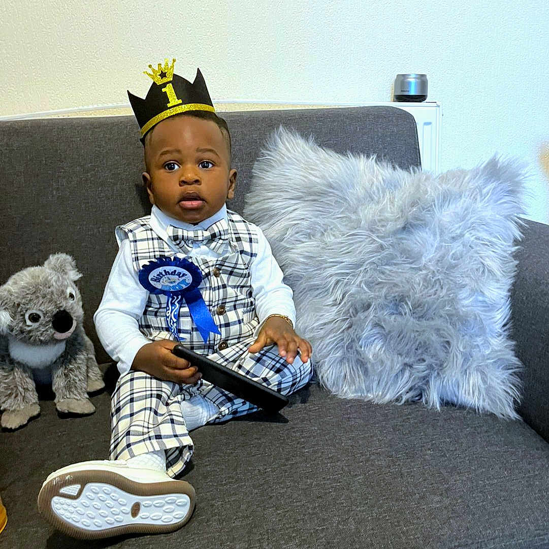 Jad Kylian joined the competition — help win amazing prizes! birthday, bowtie, celebration, child, crown, cute, footwear, happy, indoor, koala, pillow, plaid_outfit, portrait, ribbon, socks, sofa, stuffed_animal, tablet, toddler, white_shirt