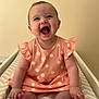 Violet is registered to the contest to win money with this photo: baby, barefoot, changing_pad, cheerful, child, cute, daisy_pattern, dress, happy, head_accessory, indoor, infant, laughing, peach_color, person, sitting, skin, smiling, young_child, zigzag_pattern