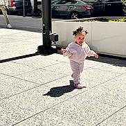 Safia joined the competition — help win amazing prizes! toddler, child, sidewalk, urban, sunlight, shadow, pole, car, parking, person, jogging_suit, pink_shoes, happiness, outdoor, daytime, concrete, street, walking, city, casual_clothing