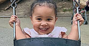 Safia joined the competition — help win amazing prizes! toddler, child, swing, playground, outdoor, happy, smile, curly_hair, park, chains, black_swing, summer_clothing, young_child, holding_on, fun, recreation, trees, daylight, casual_wear, joy