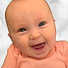 Laken is registered to the contest to win money with this photo: baby, background_blur, child, closeup, clothing, cute, expression, eyes, face, happy, head, human, infant, joy, mouth, peach_shirt, portrait, skin, smiling, young